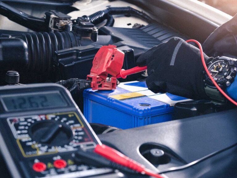 auto technician at bedhampton tyres doing a free battery test