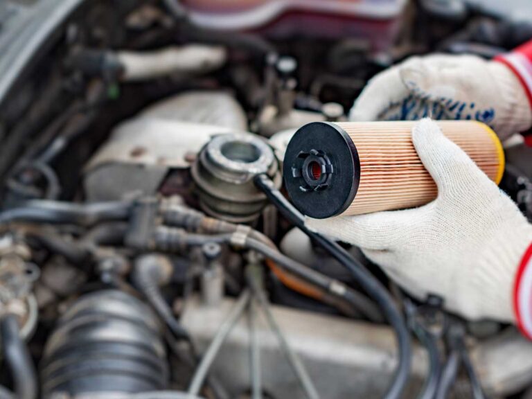 mechanic at bedhampton tyres changing an oil filter on a car