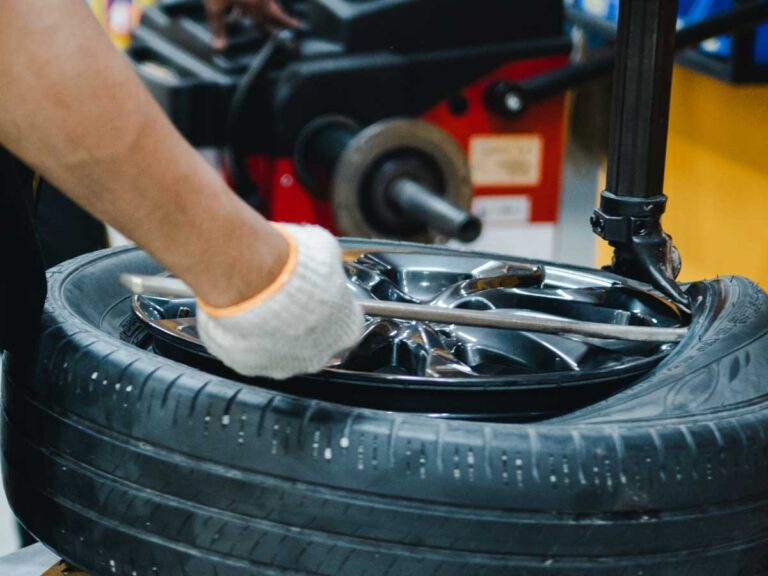 tyre technician removing the tyre off a wheel in the workshop at Bedhampton Tyres