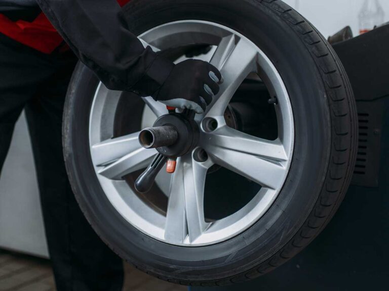 Car tyre showing a wheel balancing wing nut attached