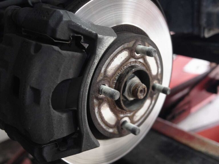 englarged view a brake, pads and calipers on a car being replaced